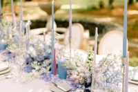 09 a beautiful and elegant wedding tablescape done in neutrals but with a periwinkle floral runner, blue, lilac and blush thin and tall candles