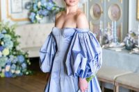 10 a jaw-dropping Bridgerton-inspired bridal look with a gorgeous royal blue off the shoulder wedding dress with a corset and puff sleeves