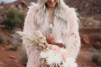 11 a light pink fuzzy fur coat over a rose gold sequin sheath wedding dress for a bold and edgy boho wedding look