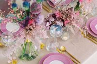 12 a unique iridescent wedding tablescape with bold florals in all the colors possible, purple plates, blue napkins, candles