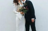 14 a plain midi wedding dress with a V-neckline, bell sleeves and gold mules for a trend-loving bride