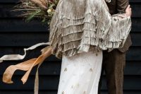 a unique bridal jacket fully covered with long grey fringe in tiers on the back is a gorgeous idea for a boho wedding