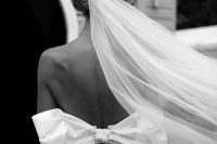 15 an adorable fitting wedding dress with an open back and a large bow plus a long veil for a dreamy and very romantic wedding look