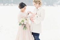16 a pink wedding dress with a layered full skirt plus a matching pink jumper over the dress to keep the bride warm in the snow