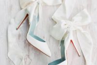 16 white wedding heels accented with oversized white ribbon bows are an amazing solution for a girlish and glam bridal look