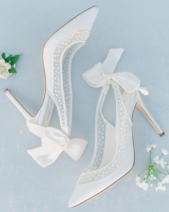 super delicat eand girlish white and semi sheer wedding shoes with pearls and white bows on the backs are adorable and chic