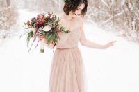 18 a simple and pretty blush strapless wedding dress with a draped bodice, a pleated skirt with a train and a greenery and burgundy bloom crown