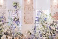 19 a gorgeous very peri wedding altar done with white and very peri blooms, candle lanterns and petals is amazing and bold