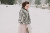 20 a winter bride rocking a pink A-line wedding dress with a layered skirt and long sleeves, a grey faux fur cover up for coziness