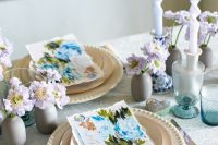 21 a delicate and chic wedding tablescape with pastel blooms, watercolor floral stationery, elegant porcelain and colored glasses