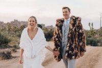 22 a groom wearing a brown spotted faux fur jacket to feel comfortable in the desert when it gets colder at night