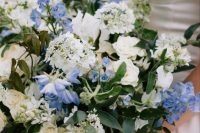 22 a lush wedding bouquet of neutral and periwinkle blooms and cascading greenery is a refined and chic idea for your wedding