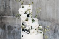 23 a beautiful black and white brushstroke wedding cake with white ranunculus and greenery is a lovely idea