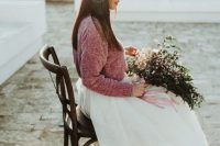 23 a winter bride wearing a white layered skirt, a pink sweater and with an airy and dreamy wedding bouquet with pink ribbons