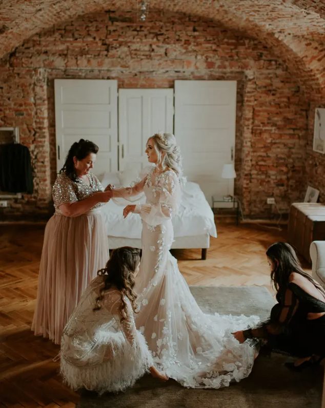 a blush mermaid wedding dress with white floral appliques a train and puff sleeves is a gorgeous fashion statement for your wedding