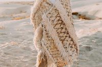 a neutral desert groom’s look with a bold accent – an embellished Moroccan wedding blanket as a cover up is jaw-dropping