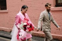26 a short patterned pink blazer wedding dress, a long white veil, statement pearl earrings and white shoes plus a whimsy bouquet