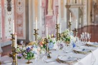 26 a sophisticated wedding tablescape with refined vintage candleholders, pastel blooms and greenery and white and blue porcelain