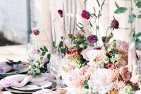27 a sophisticated wedding table setting done in lilac, blush and mauve shades, with delicate linens and lush florals plus tall and thin candles