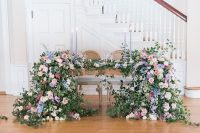 31 a gorgeous sweetheart table with lilac candles and super lush florals and greenery descending to the floor is wow
