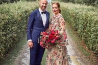 32 a beautiful and romantic A-line wedding dress with colorful floral embroidery, a high neckline, ball sleeves and a train