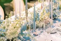 33 a fabulous wedding tablescape done with pastel blooms, pastel blue candles, neutral porcelain and neutral linens for a Bridgerton wedding