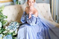 34 a Bridgerton-inspired bridal look with a serenity blue off the shoulder wedding dress with puff sleeves and matching blue florals around