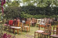 35 a lovely and cozy back garden wedding ceremony space with mismatching chairs, bright blooms and lots of greenery