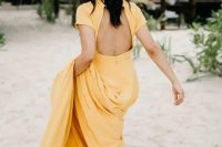 35 a yellow A-line wedding dress with a cutout back, short sleeves and a train for a tropical bride