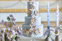 36 a fabulous textural blue wedding cake with gold and white blooming branch detailing is amazing