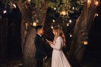 36 an intimate backyard garden evening wedding ceremony under living trees, with lots of lights and candles