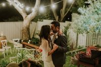 38 an intimate backyard garden wedding with simple and cozy boho decor and string lights is a cute idea