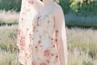 40 a delicate wedding dress in neutral shades with pink floral embroidery all over the dress and with a neutral underdress