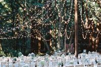 44 a refined and beautiful outdoor wedding reception with a light canopy over it that highlights it and makes it bolder