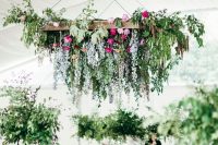 47 a beautiful and chic hanging floral decoration with greenery over the reception can substitute usual centerpieces