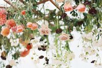 49 a ladder with hanging white, peachy, coral, orange and deep purple blooms and greeneyr as a beautiful overhead installation for a wedding reception