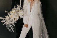 51 a chic white pantsuit with cropped pants, sheer heels and a long veil with sequins for a comfy reception look
