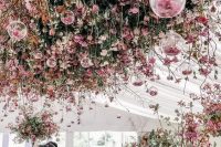 51 a jaw-dropping wedding reception space fully done with pink and coral florals all over including overhead hanging installations is wow