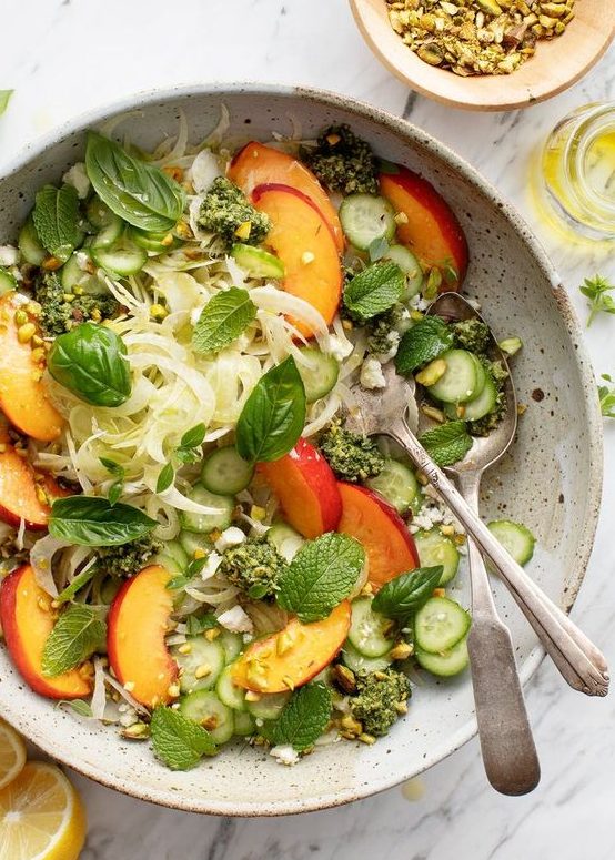 late summer salad with crisp fennel, juicy peaches, creamy pesto, basil and cucumbers is a refreshing and not hearty dish for a vegan wedding