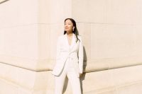 56 a chic bridal pantsuit with a top, a long blazer, flare pants and statement earrings for ultimate elegance