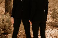 58 brides wearing matching black pantsuits with cropped pants, white shirts and black ties are amazing