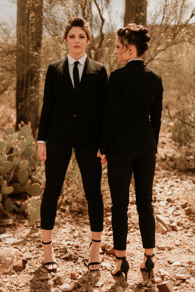 brides wearing matching black pantsuits with cropped pants, white shirts and black ties are amazing