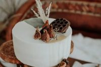 60 a simple buttercream wedding cake topped with figs, lotus and grasses is a gorgeous idea for a fall wedding