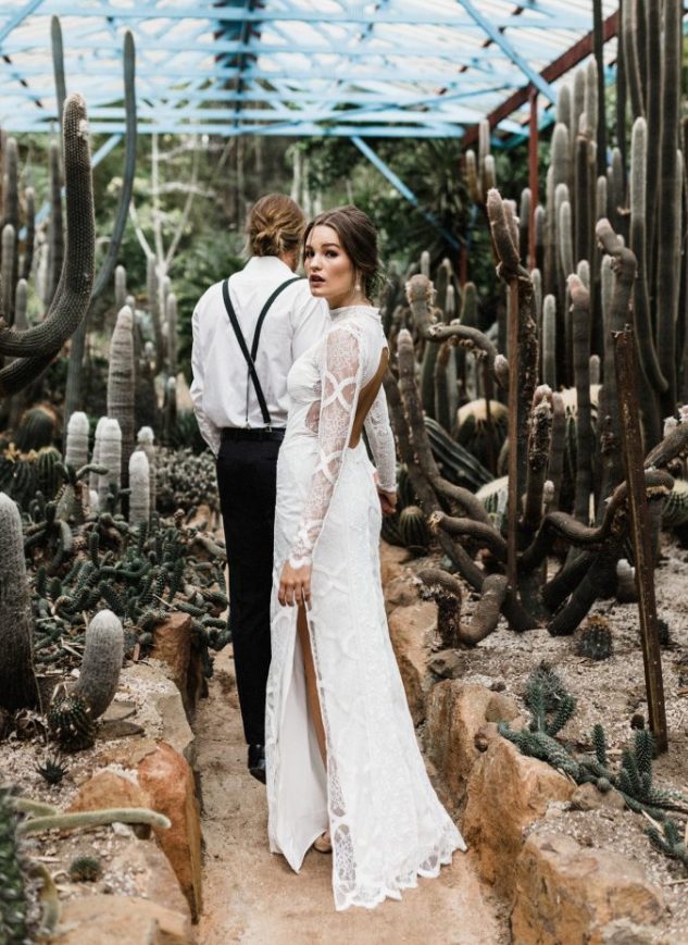 a sexy lace sheath wedding dress with a turtleneck, a side slit and a cutout back plus long sleeves