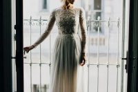 67 a high neckline long sleeve wedding dress with an embroidered and embellished bodice and a plain skirt