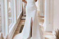 71 an ultra-modern plain fitting wedding dress with a high neckline, short sleeves, a front slit and a train for a minimalist bride