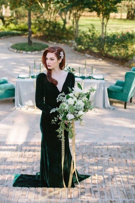 a beautiful forest green velvet wedding dress with a deep neckline, long sleeves and a train looks super exquisite