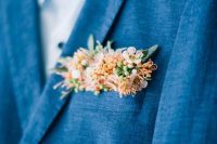 a bright blue blazer and a delicate floral pocket square done in blush and peachy, with little blooms, berries and leaves is chic