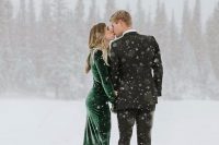 a green velvet mermaid wedding dress with a train and long sleeves is a gorgeous color statement and looks amazing in the snow