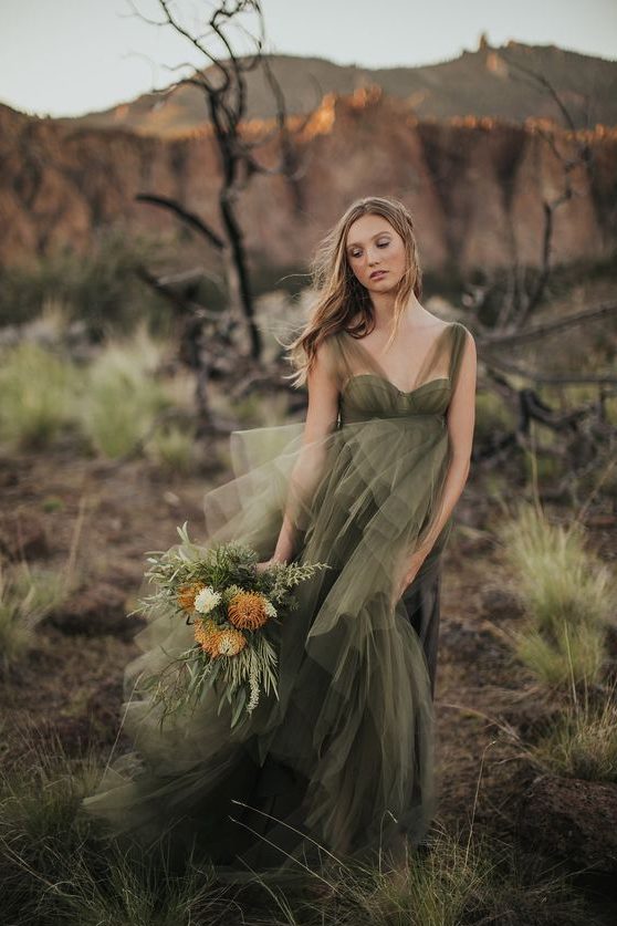 a moody green wedding dress with wide illusion straps, a sweetheart neckline and a layered tulle skirt for a moody fall bride